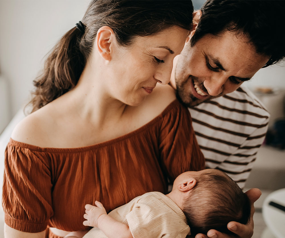 couple holding a baby with nice ears | Arslanian Plastic Surgery Atlanta