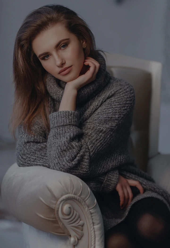 woman sitting with a big turtle neck | Arslanian Plastic Surgery Atlanta